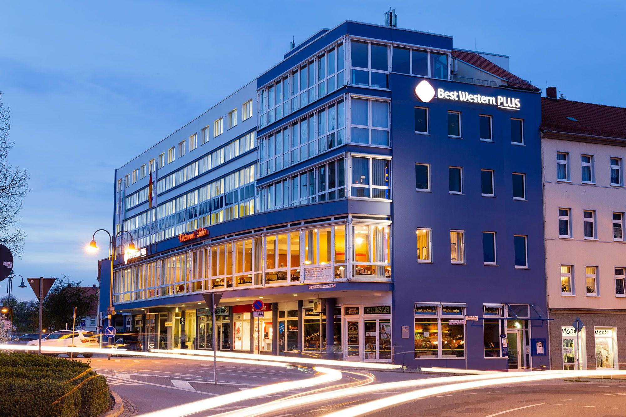 Modernes Hotelgebäude in Bautzen bei Abenddämmerung, mehrstöckig mit großen Fenstern und warmer Außenbeleuchtung.
